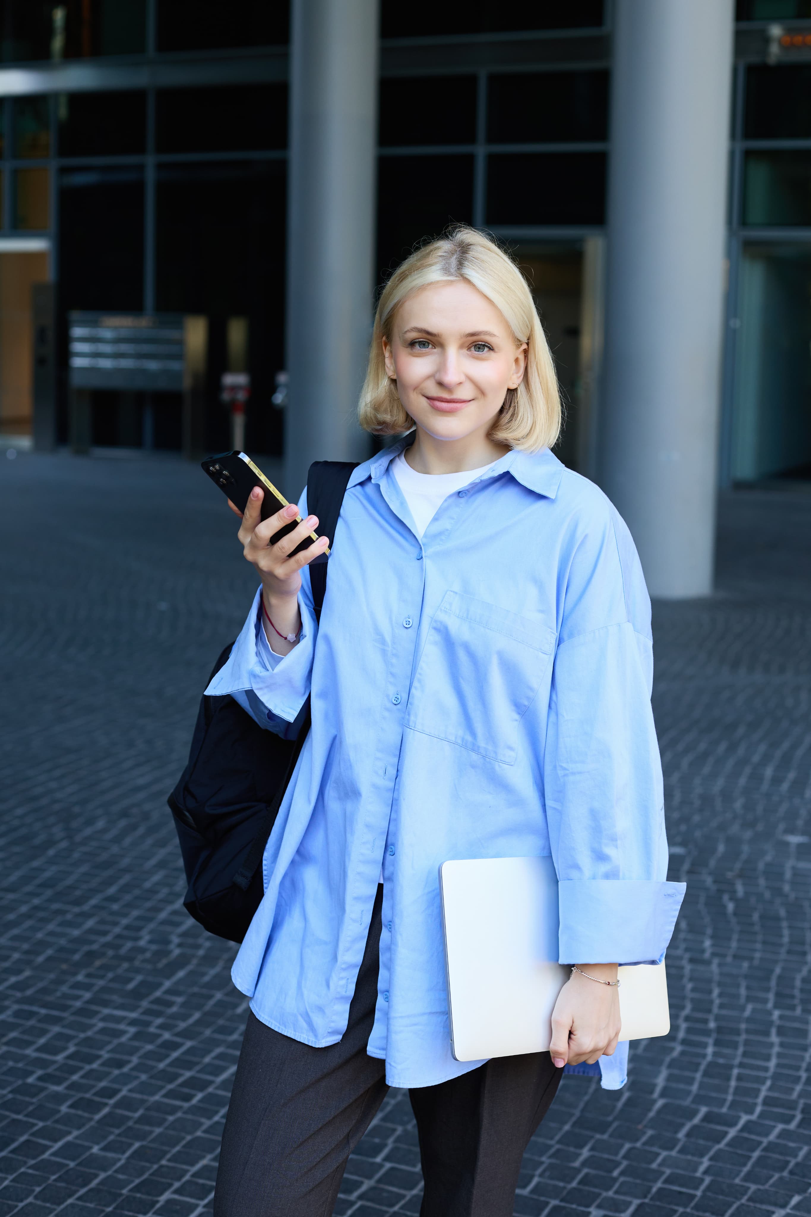 Student with laptop and phone